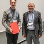 EMS2022 Awards ceremony: Johannes Mikkola, winner of the Young Scientist Conference Award, with Vice President Dominique Marbouty (right)